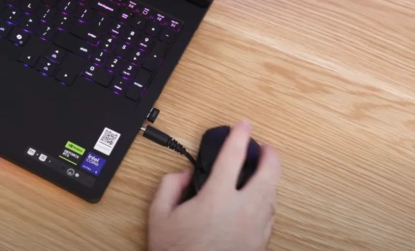 Side view of Lenovo Legion Pro 7i showing front-positioned ports that may interfere with mouse movement during gaming.