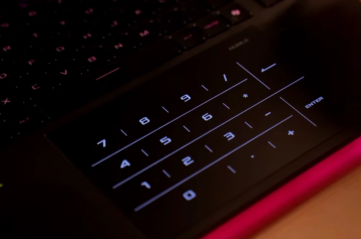 ASUS ROG Strix G16 NumPad trackpad showing numpad overlay with pink accent lighting